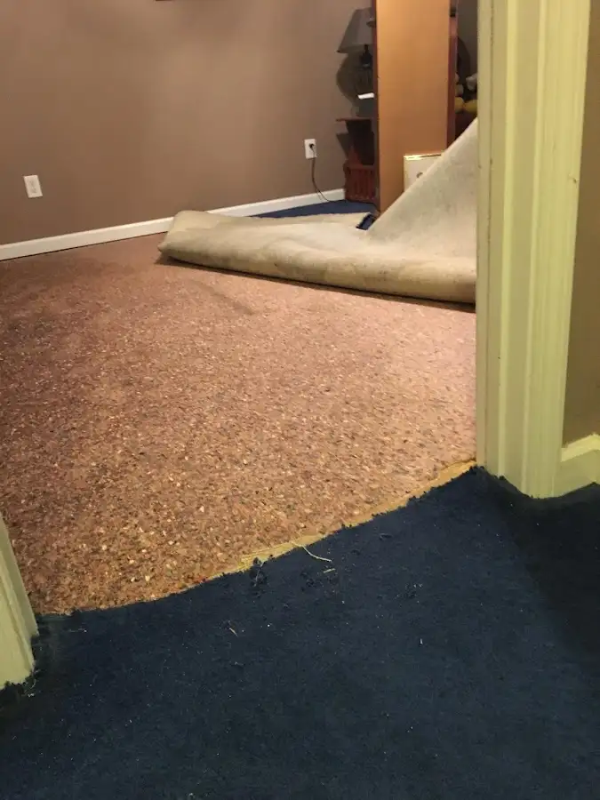 Carpet pad removal revealing water damage during Water Mitigation Services in Santa Clarita